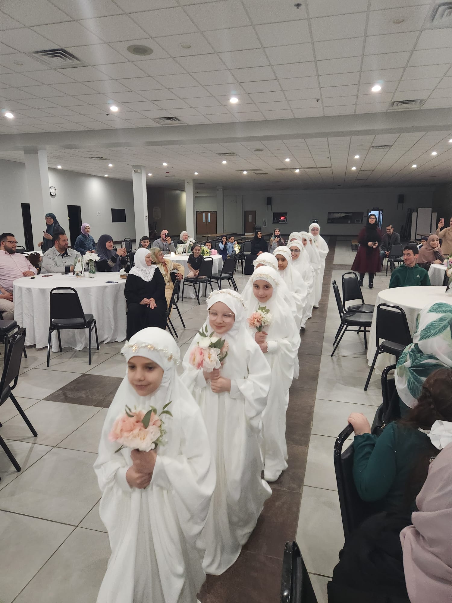 Children in White Robes Holding Flowers, Symbolizing Purity and Innocence.